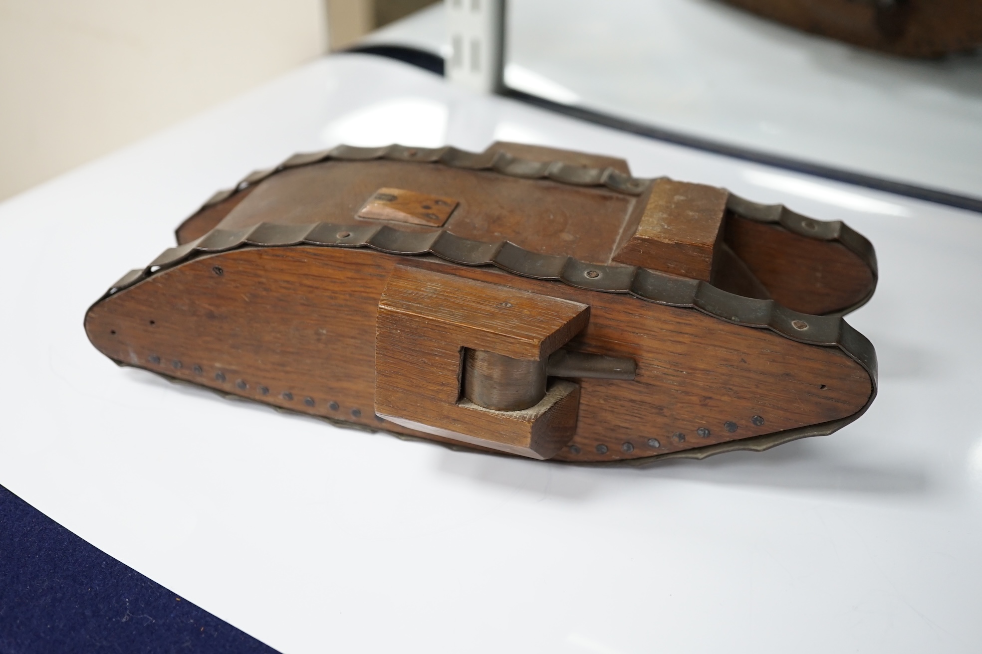 A Trench art tank, a parquetry box including paste and silver brooch and mixed collectables, box 30cm x 20cm. Condition - tank, box and brooch good, other contents variable